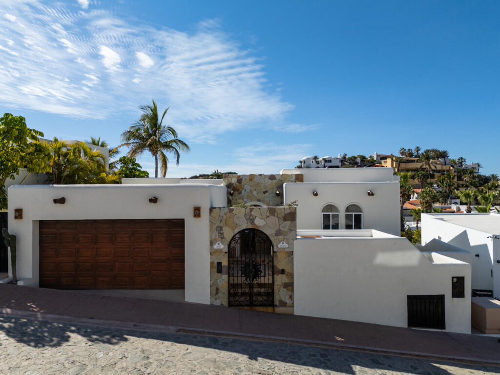 Cabo San Lucas Blue Moon La Casa Bendecida, (The Blessed House), blends luxury, comfort, and convenience. This lovingly designed villa evokes a peaceful, refined ambiance, filled with the color and vibrancy of Mexico. Situated in the private community of El Pedregal, known as the ''The Beverly Hills of Cabo San Lucas,'' this gated community offers 24 hour security, cobblestone streets, lush landscaping, a beautiful private beach, and access to the exclusive owners only Mountain Club with a restaurant, gym, tennis courts, and pickleball courts.La Casa Bendecida is inspired by Mexico's rich traditions and craftsmanship, including Talavera tile, Palo de Arco wood, brick ceiling arches, and colorful folk art. A magnificent art collection enhances the villa's spaces. The layout maximizes indoor-outdoor living with numerous lovely areas to gather, including scenic outdoor terraces and portals. Windows frame postcard-worthy glimpses of the Sea of Cortez and the Pacific Ocean, with gorgeous sunrises and sunsets. The flowing open concept of this villa connects the spacious main living room, the well-equipped kitchen, and the dining room. Each of the four bedrooms offer unique themed design, decor and vibrant artistic touches paying homage to Mexican art, folklore, and local natural landscapes. There are 3 full bathrooms and a gorgeous talavera tiled outdoor shower. Outdoor living features a hot tub, swiimming pool, a Bar-height Fire Pit Dining Table, tables and chairs for relaxation around the pool, a dining table that seats 8 and several lovely portals with talavera tiled steps. There is even a swing for two to enjoy the breathtaking sunsets over the Pacific.La Casa Bendecida was transformed and remodeled and redesigned in 2021 by the current owners, who chose to return it to a home that reflected all that they love about Mexico. It is offered completely turnkey for a buyer seeking a fully furnished, income producing property. Everything needed to continue on with this proven rental performance home is provided for you. Overlooking the gorgeous park setting of the Valley of the Blue Moon, La Casa Bendecida is a seven minute walk to the beach. The recently updated Blue Moon Park common area offers exercise equipment and walking paths.Additional features include fiber optic WiFi, HD Smart TVs, mini split air conditioning, ceiling fans in every room, an Alexa sound system, a whole house water purification system, 2 sets of washer dryers, and a large full garage with lots of storage areas.La Casa Bendecida welcomes you with open arms as you make cherished memories here that will last a lifetime.Notes:This home has been completely renovated twice in the past 10 – La Casa Bendecida, Cabo San Lucas, BS